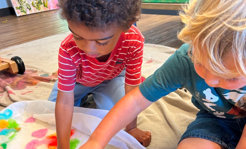 Two children playing with colors