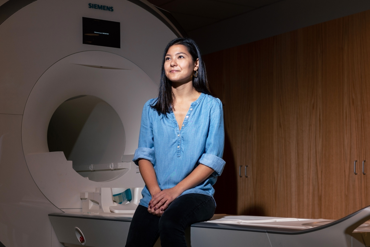 Woman sitting with MRI machine